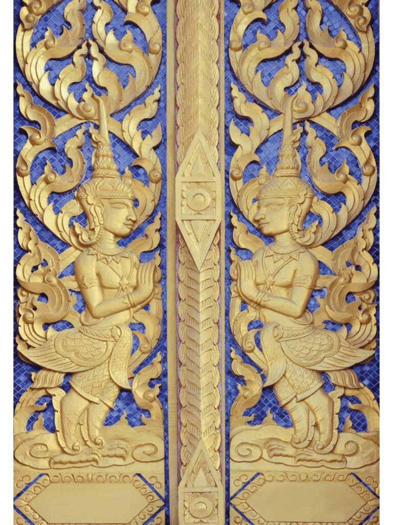 Traditional wooden main door with ornate idol design