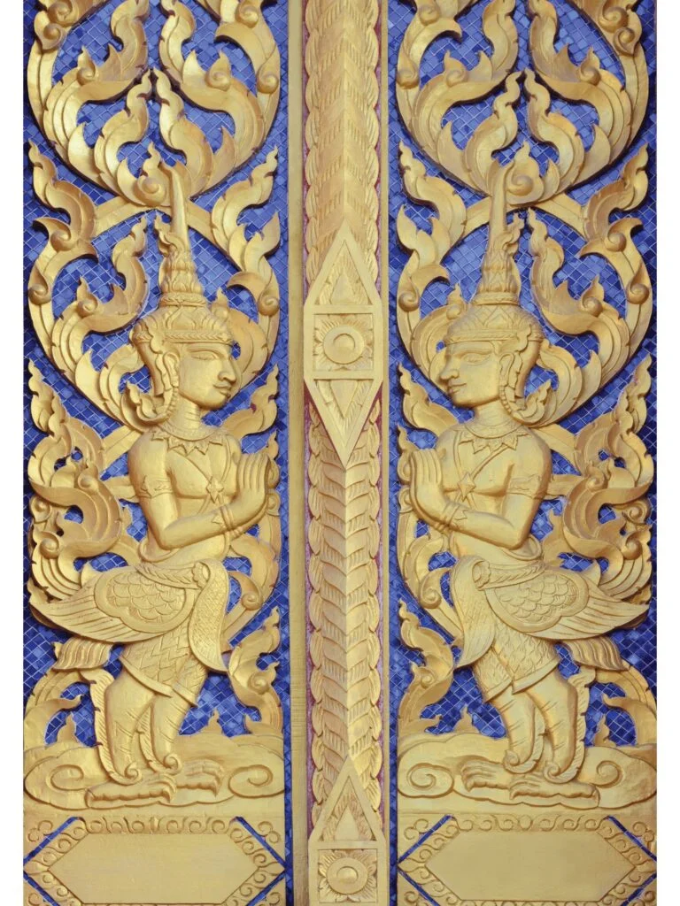 Traditional wooden main door with ornate idol design